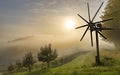 Misty sunset behind a Klapotetz and grape hills on the Weinstrassee  at Grassnitzberg near Spielfeld / Leibnitz / Austri Royalty Free Stock Photo